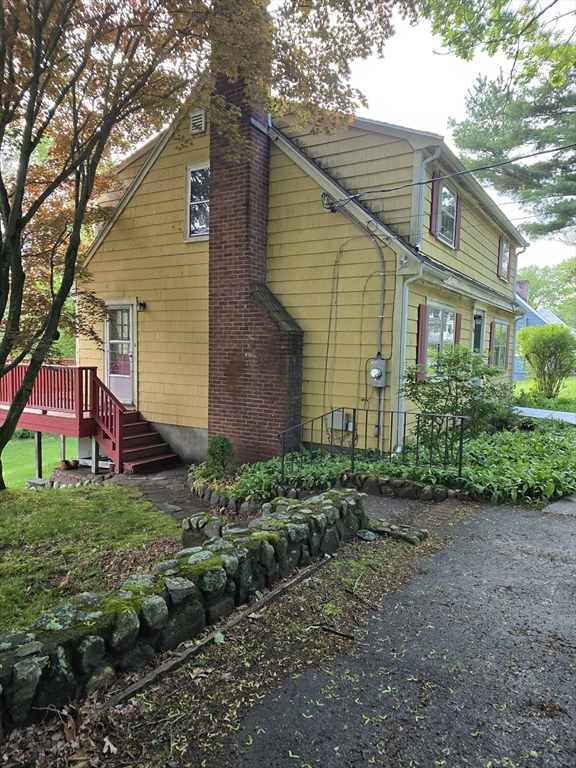 150 Grove Street Reading, MA 01867 - Photo 5 of 20 a view of a yard in front of a house
