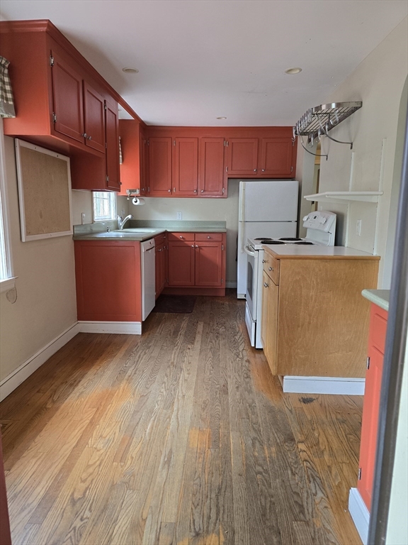 150 Grove Street Reading, MA 01867 - Photo 6 of 20 a kitchen with stainless steel appliances wooden cabinets a stove top oven a sink and dishwasher