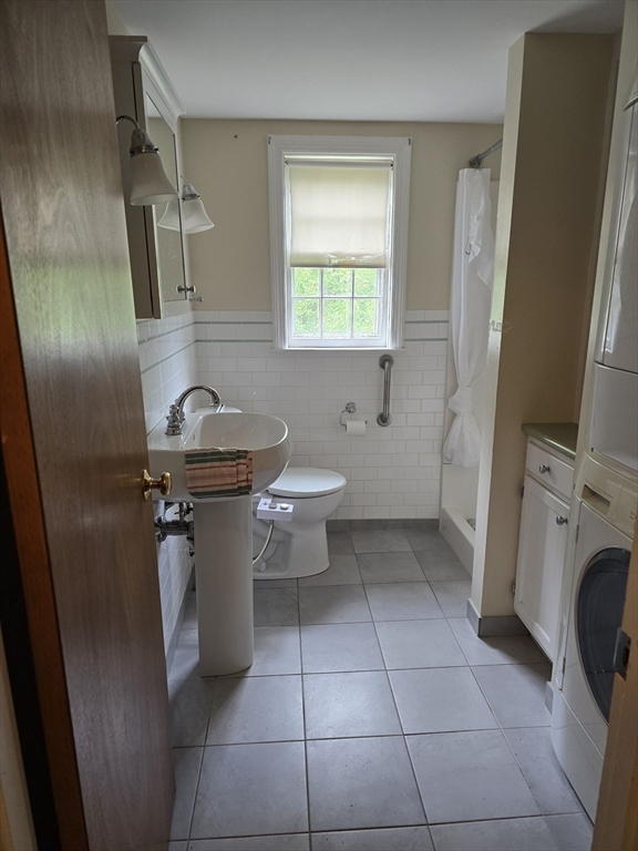 150 Grove Street Reading, MA 01867 - Photo 9 of 20 a bathroom with a sink toilet and shower