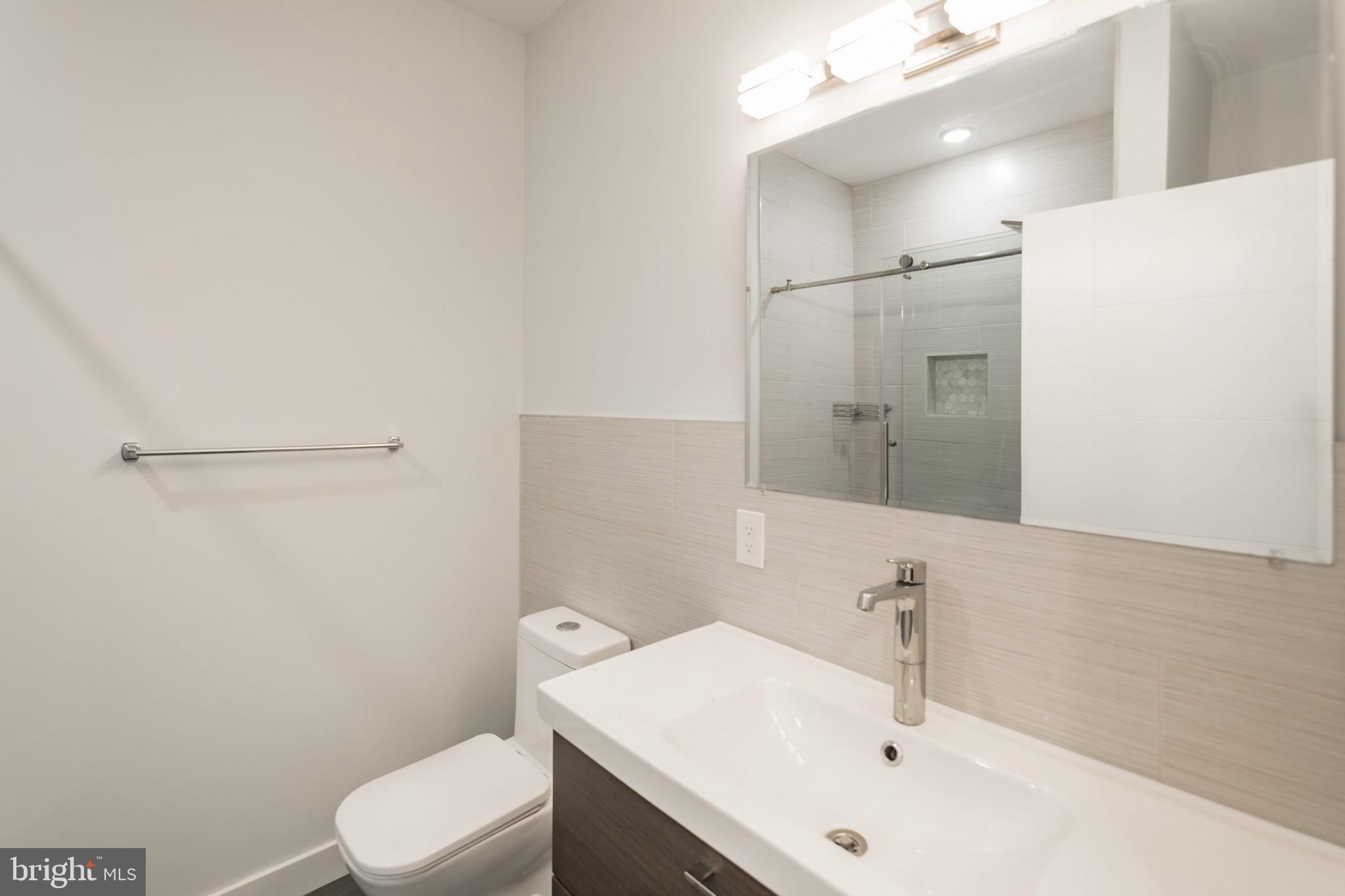 627 West Oxford Street, Unit 2 Philadelphia, PA 19122 - Photo 5 of 14 a bathroom with a sink a toilet and shower