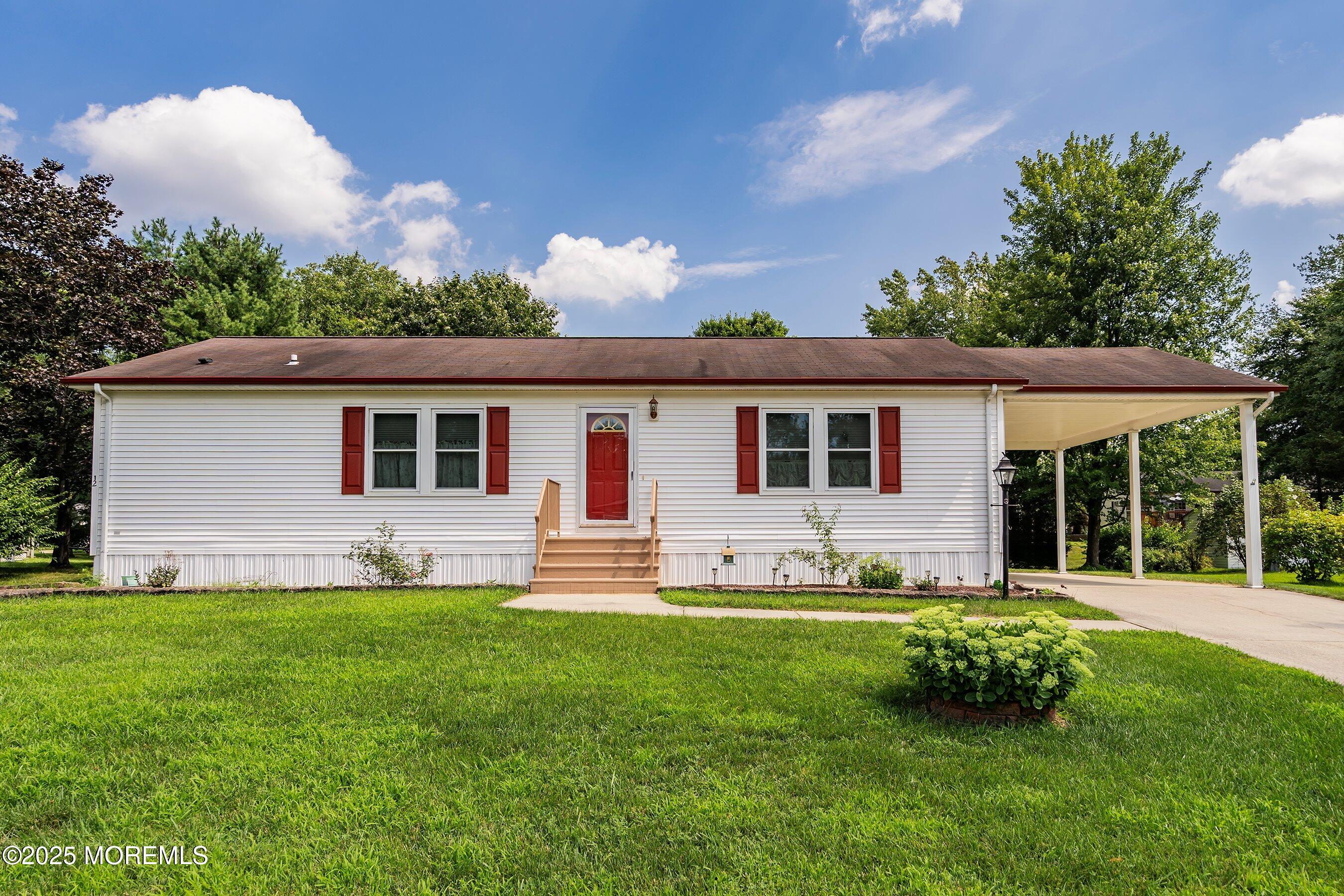 a front view of house with yard and green space