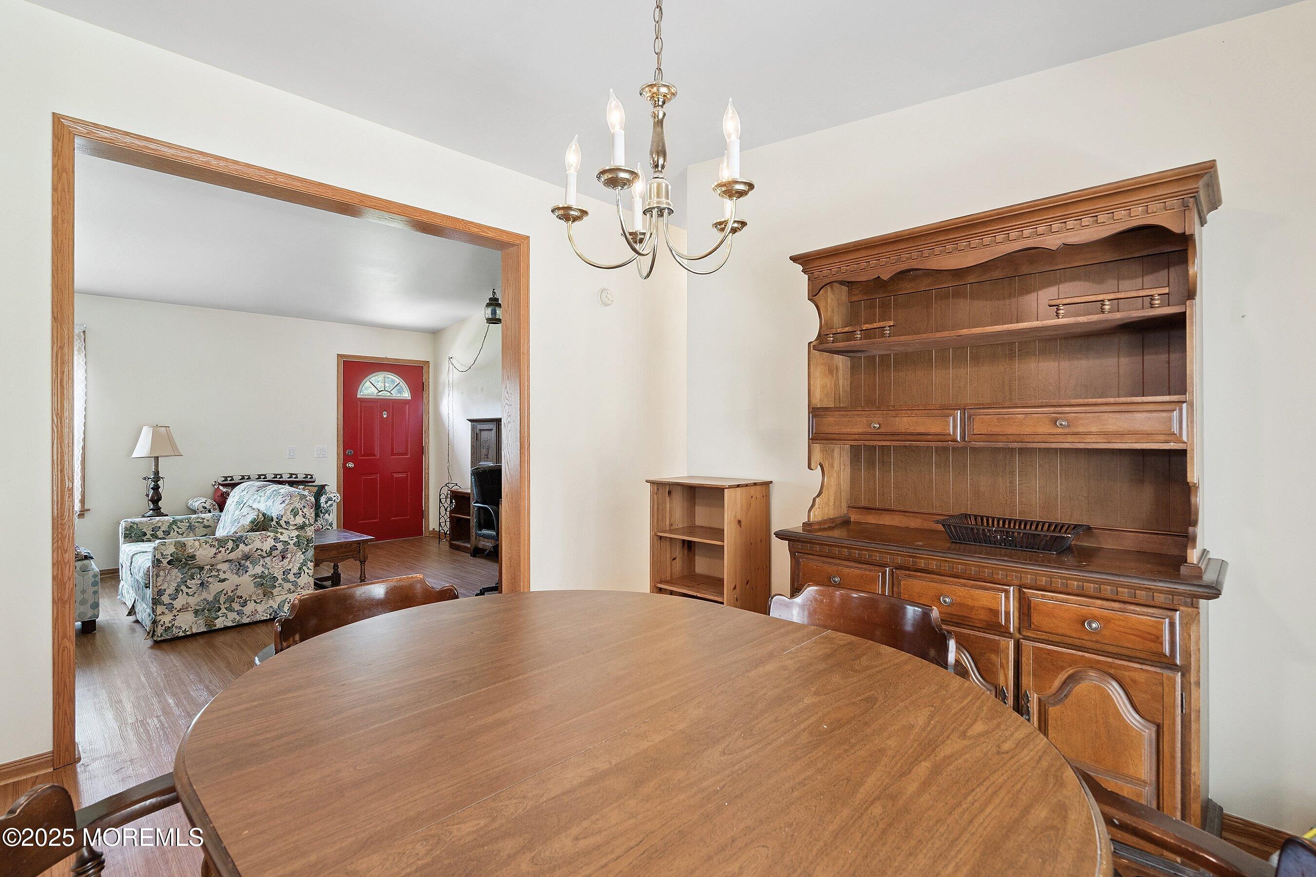 12 Copperfield Drive Cream Ridge, NJ 08514 - Photo 19 of 33 a bedroom with a bed and a chandelier