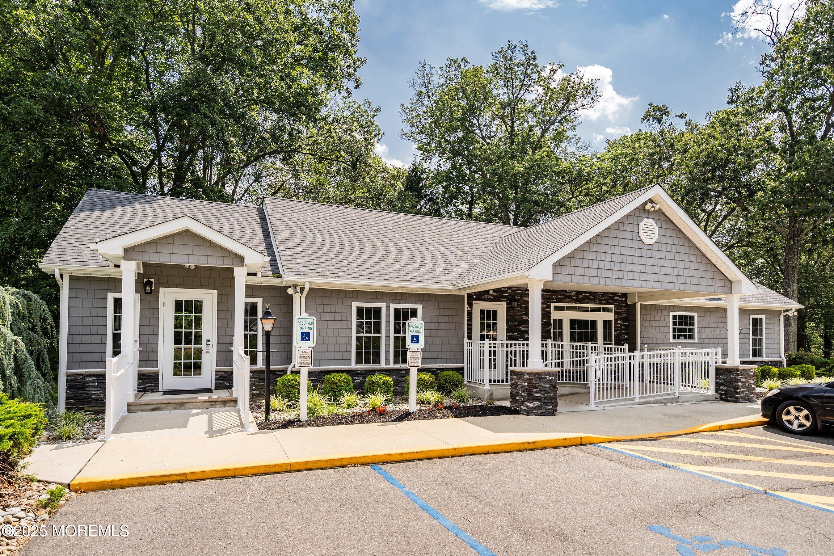 12 Copperfield Drive Cream Ridge, NJ 08514 - Photo 28 of 33 a view of a white house with large windows and plants and large tree