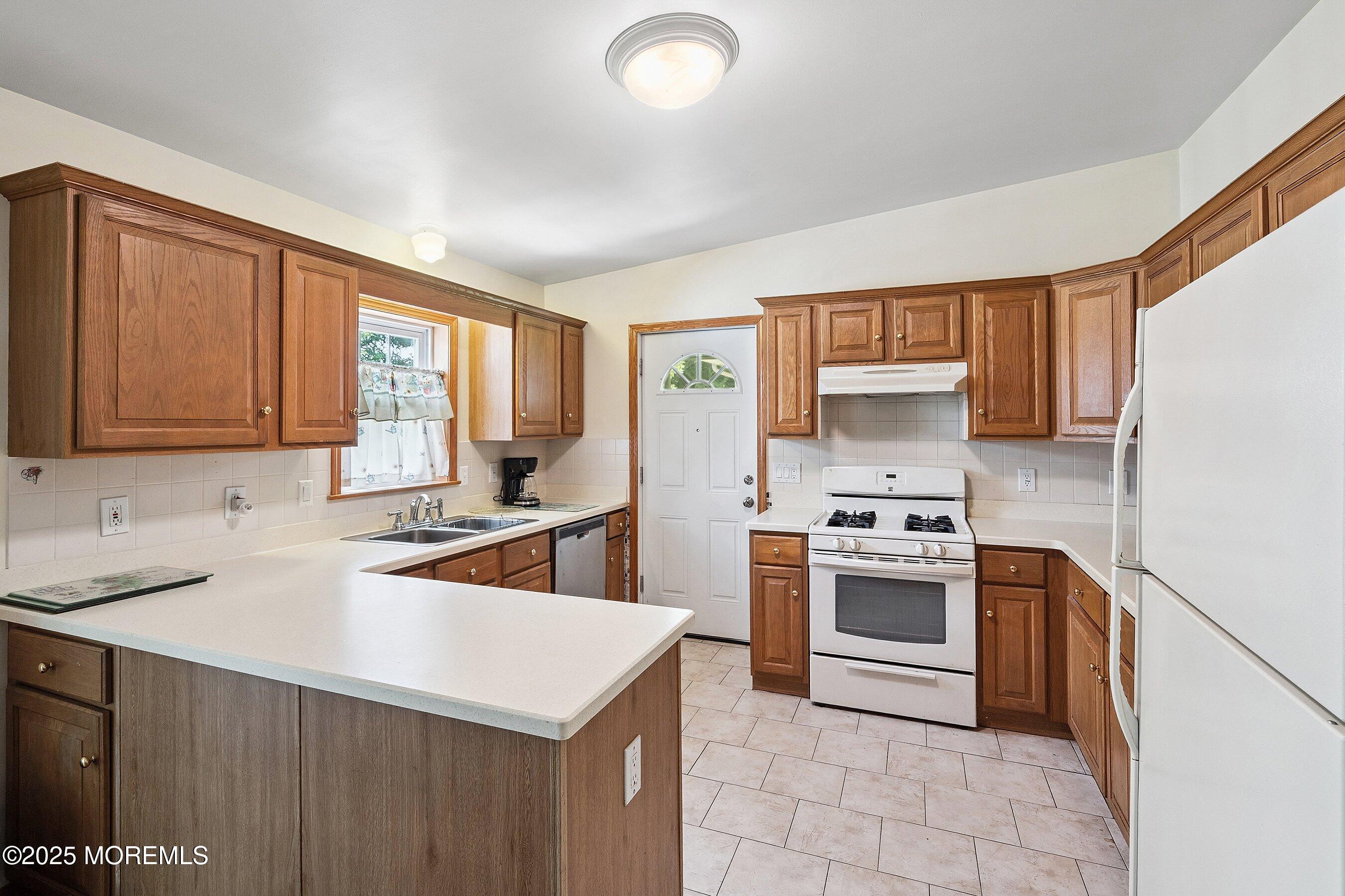 12 Copperfield Drive Cream Ridge, NJ 08514 - Photo 10 of 33 a kitchen with stainless steel appliances granite countertop a sink stove refrigerator and cabinets