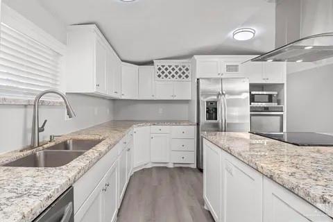 35619 General Brant Road Rio Hondo, TX 78583 - Photo 12 of 21 a kitchen with granite countertop a sink stainless steel appliances and white cabinets
