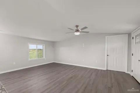 35619 General Brant Road Rio Hondo, TX 78583 - Photo 5 of 21 wooden floor in an empty room with a window
