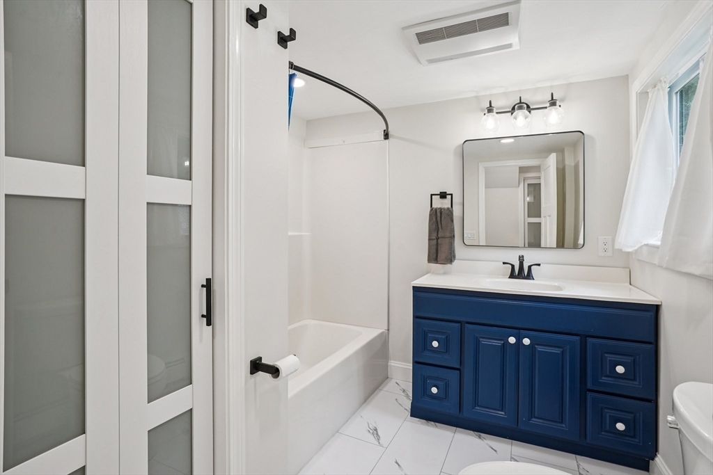 44 Richardson Corner Road Charlton, MA 01507 - Photo 14 of 31 a bathroom with a granite countertop sink vanity and mirror