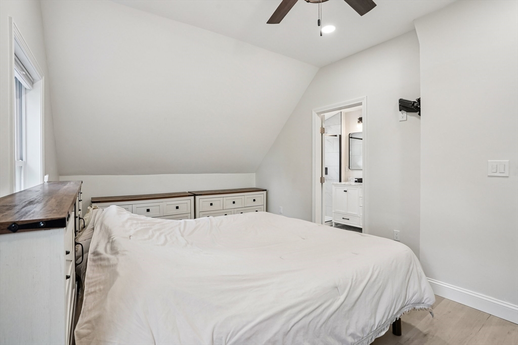 44 Richardson Corner Road Charlton, MA 01507 - Photo 16 of 31 a bedroom with a bed and a chandelier