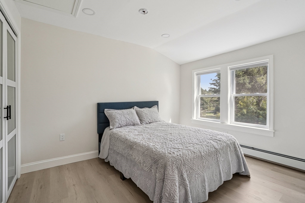 44 Richardson Corner Road Charlton, MA 01507 - Photo 22 of 31 a large bed sitting in a bedroom next to a window