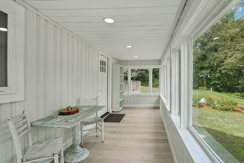 44 Richardson Corner Road Charlton, MA 01507 - Photo 26 of 31 a view of a patio with table and chairs with wooden floor and fence