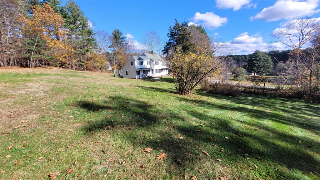 44 Richardson Corner Road Charlton, MA 01507 - Photo 29 of 31 a view of a green yard with large trees