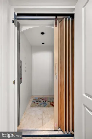 a bedroom with bed and glass door