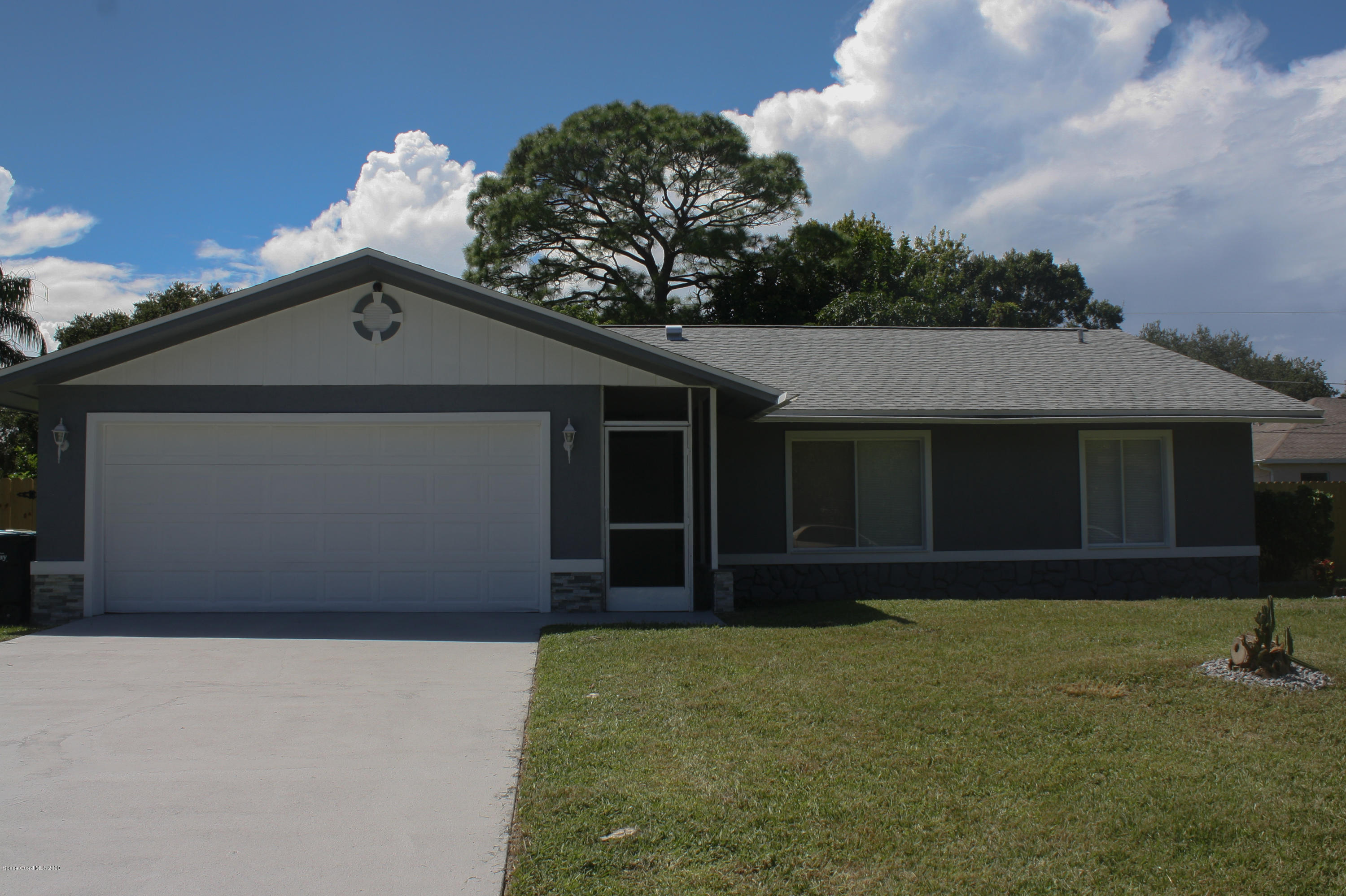 326 Riley Avenue Northeast Palm Bay, FL 32907 - Photo 1 of 43 a front view of a house with a yard