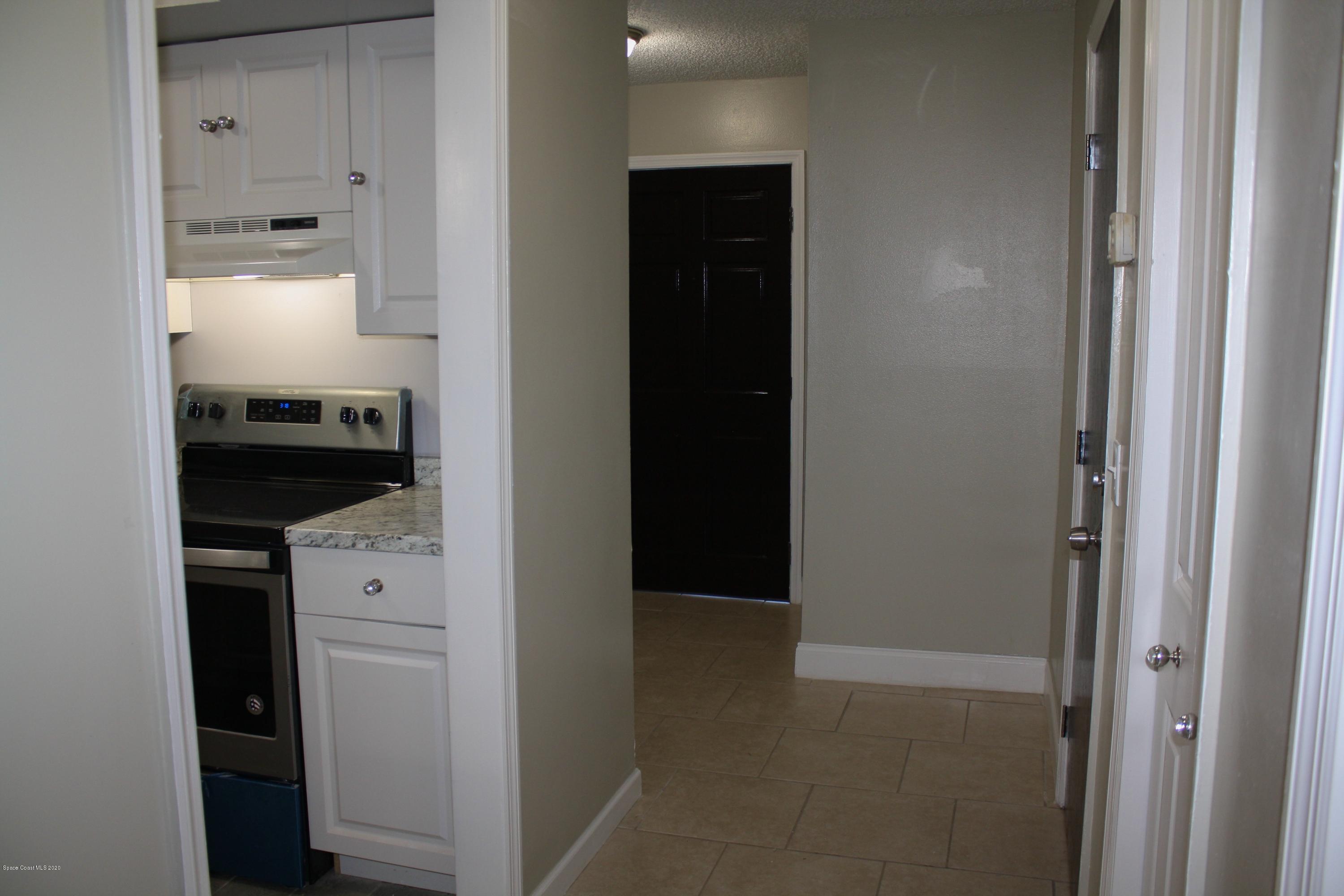 326 Riley Avenue Northeast Palm Bay, FL 32907 - Photo 11 of 43 a kitchen with a refrigerator and cabinets