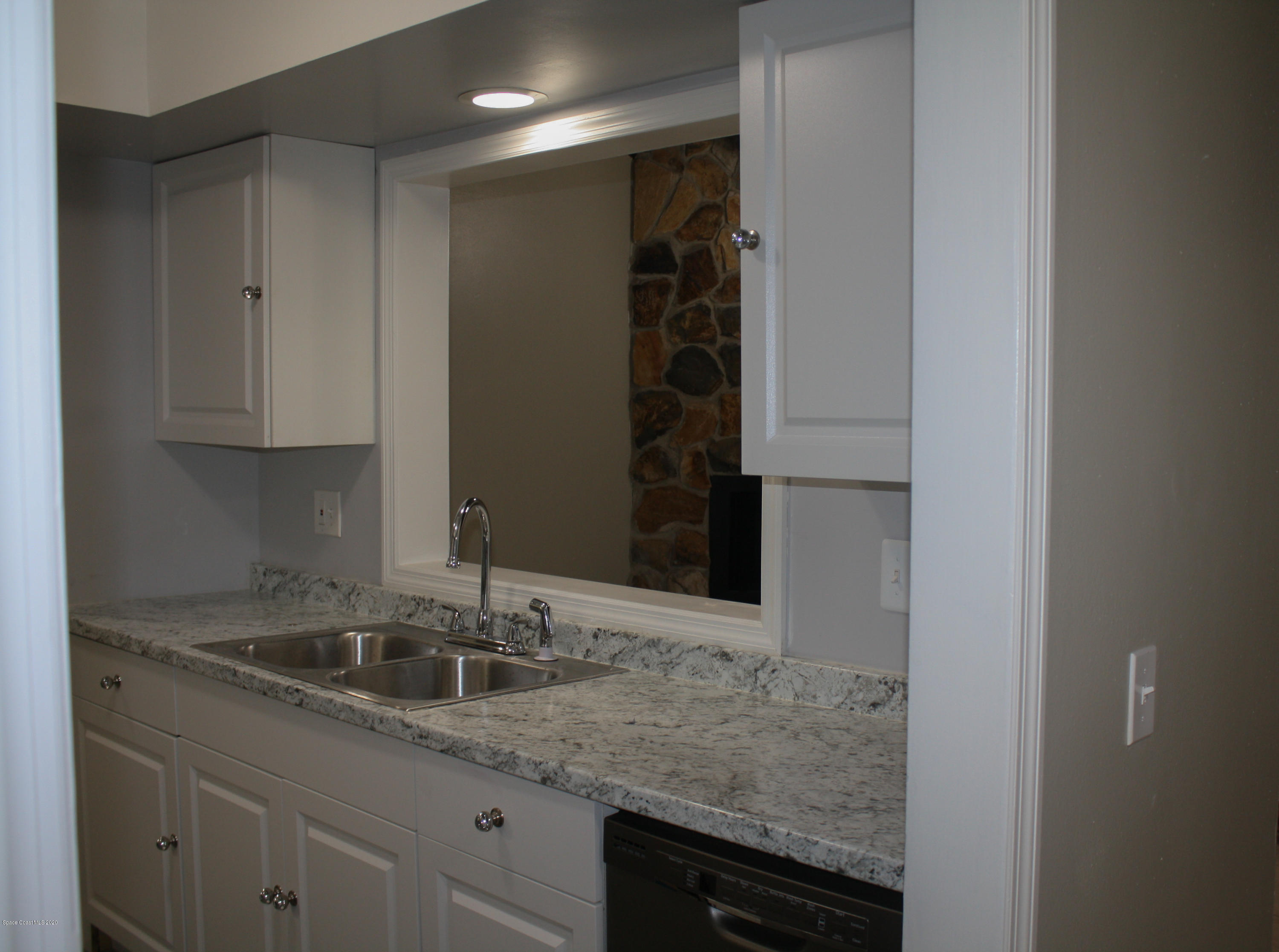 326 Riley Avenue Northeast Palm Bay, FL 32907 - Photo 12 of 43 a kitchen with a sink and cabinets