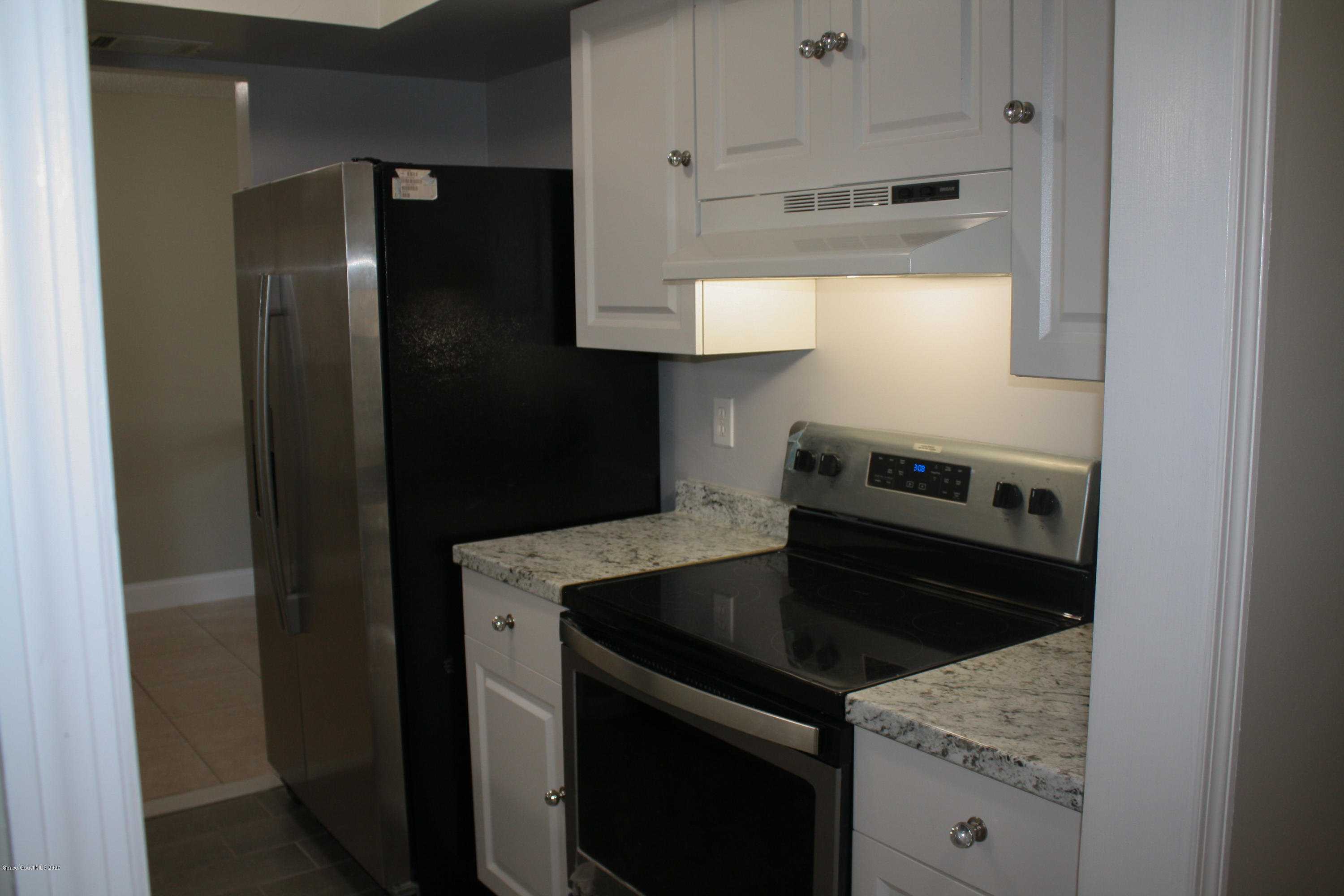 326 Riley Avenue Northeast Palm Bay, FL 32907 - Photo 13 of 43 a kitchen with a stove microwave and refrigerator