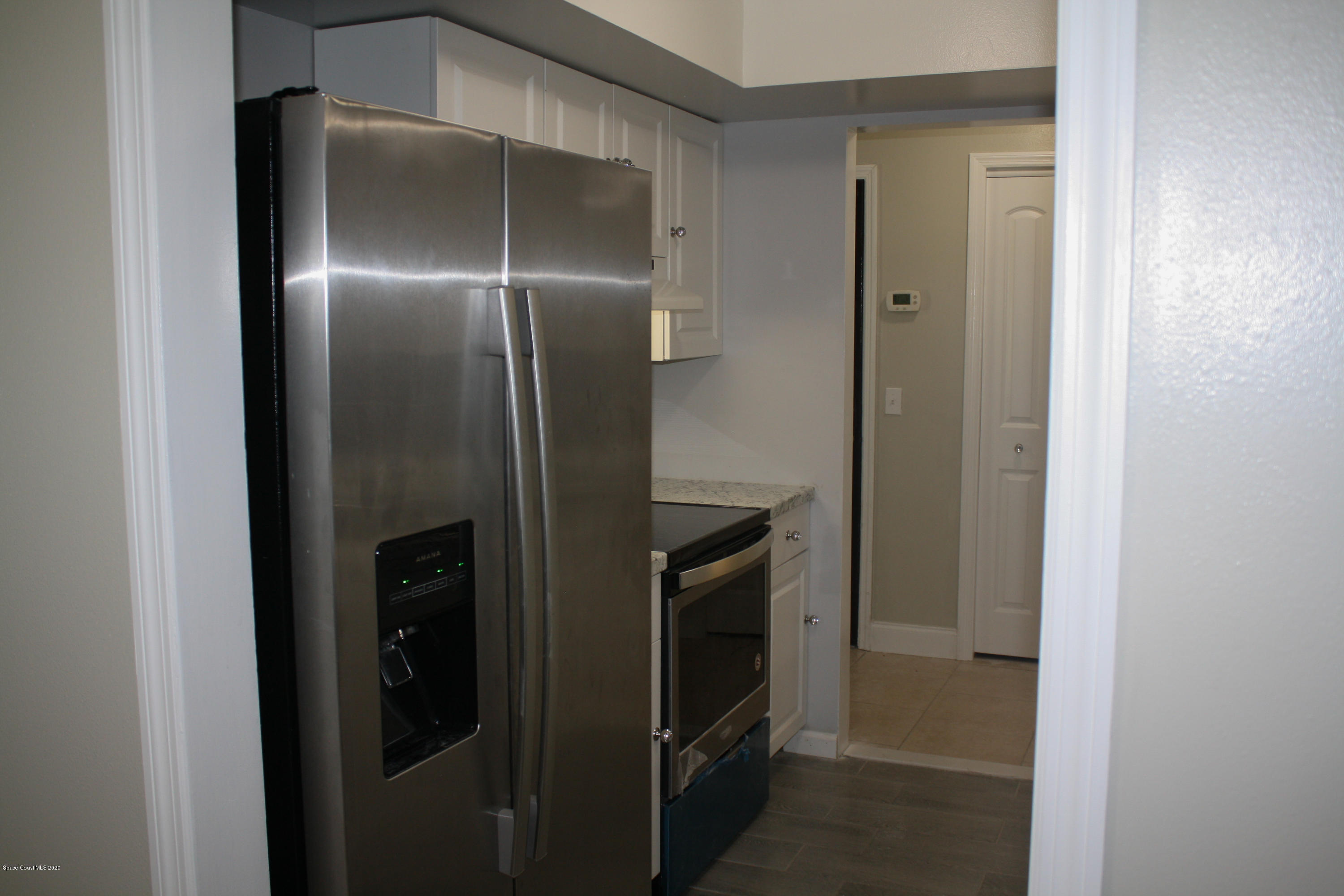 326 Riley Avenue Northeast Palm Bay, FL 32907 - Photo 14 of 43 a metallic refrigerator freezer and a refrigerator in a kitchen