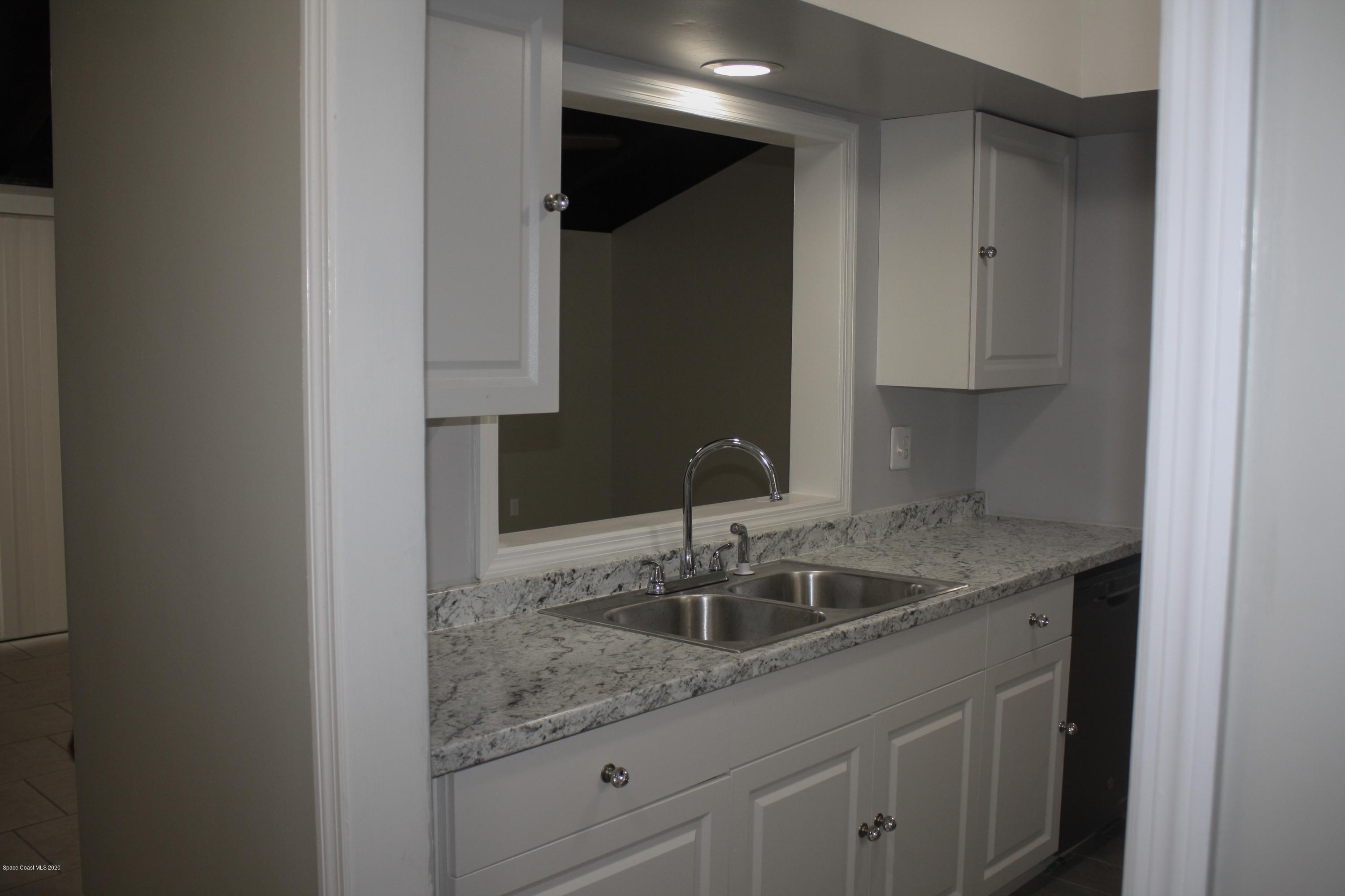 326 Riley Avenue Northeast Palm Bay, FL 32907 - Photo 15 of 43 a kitchen with a sink and cabinets