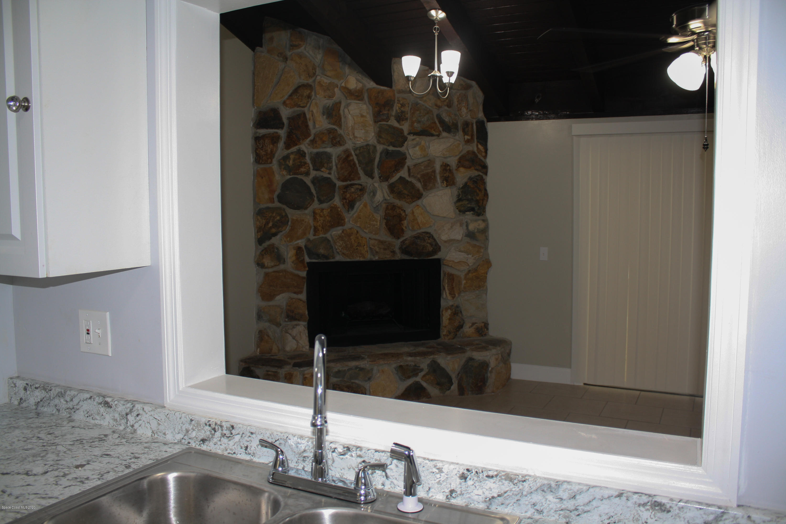 326 Riley Avenue Northeast Palm Bay, FL 32907 - Photo 16 of 43 a bathroom with a granite countertop sink a mirror and shower