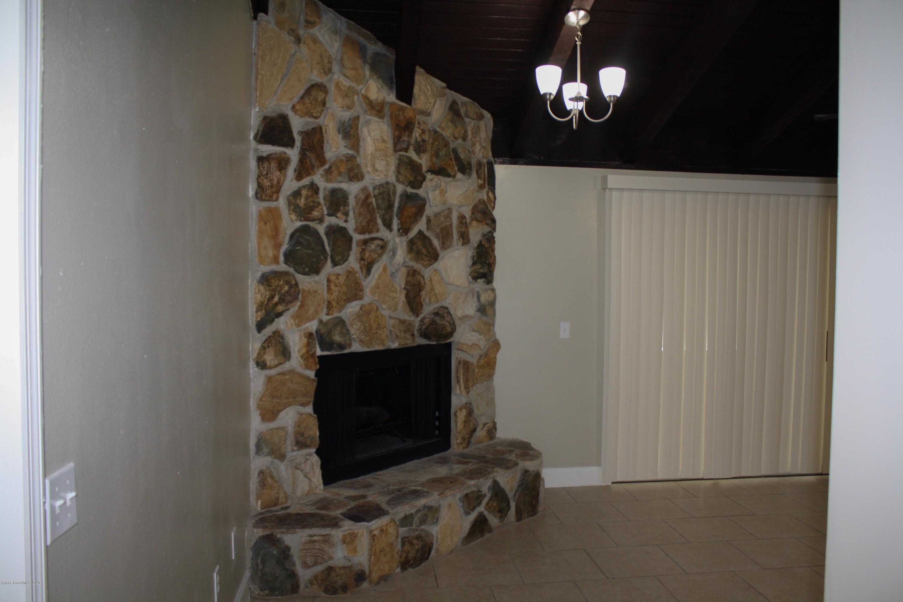 326 Riley Avenue Northeast Palm Bay, FL 32907 - Photo 19 of 43 a living room with furniture and a fireplace