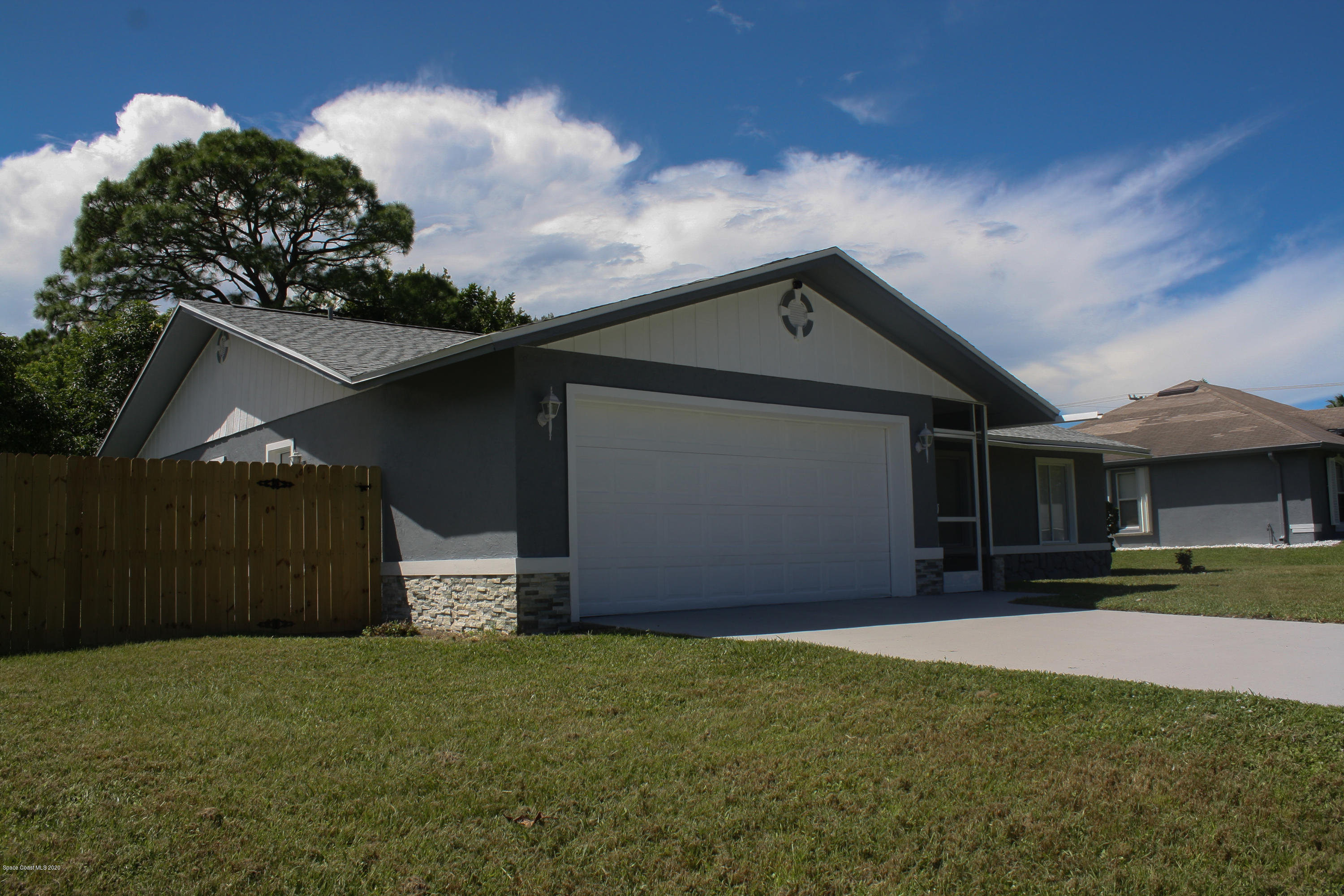 326 Riley Avenue Northeast Palm Bay, FL 32907 - Photo 3 of 43 a front view of a house with a yard