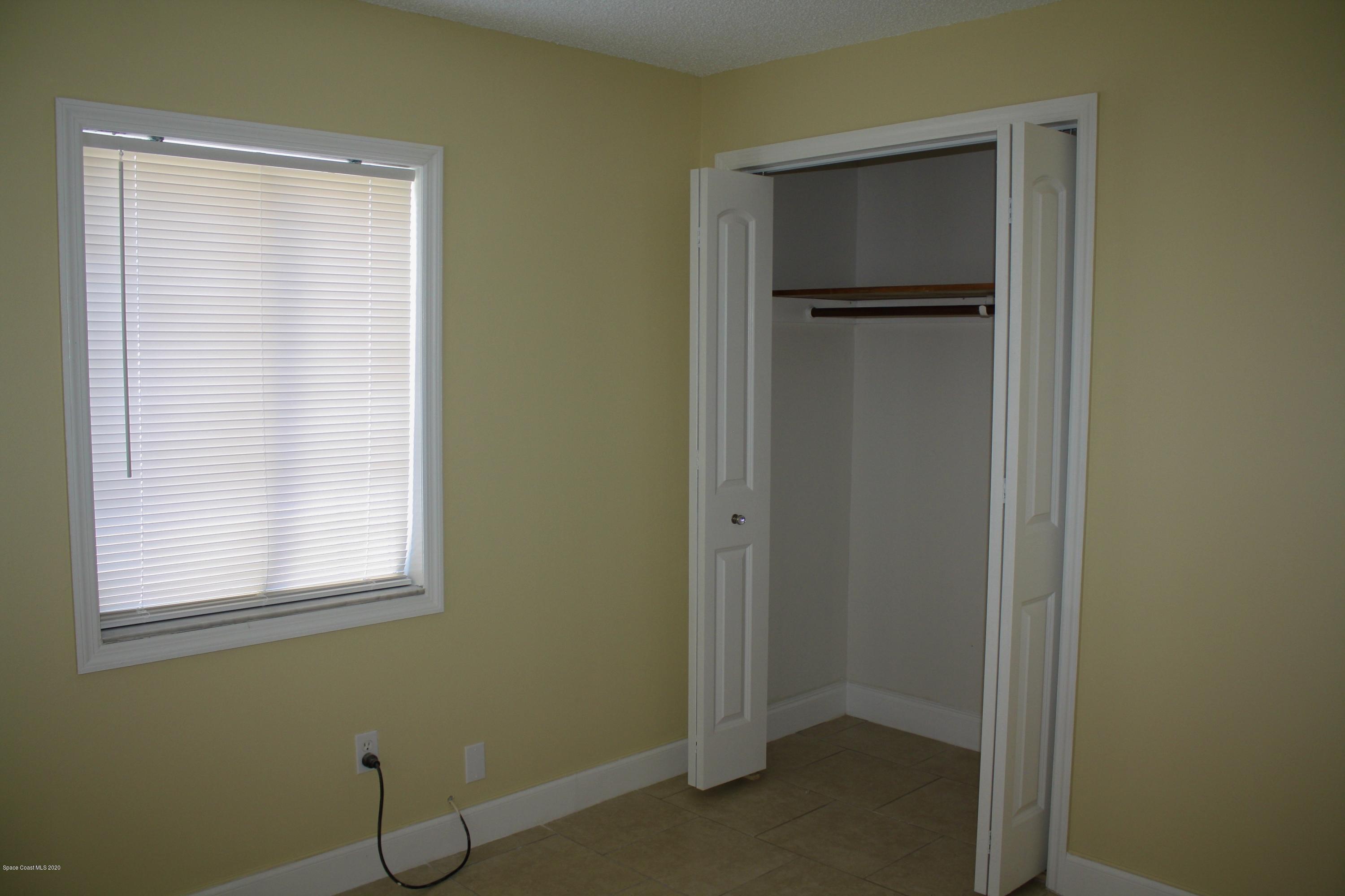 326 Riley Avenue Northeast Palm Bay, FL 32907 - Photo 22 of 43 a view of an empty room with closet and a window
