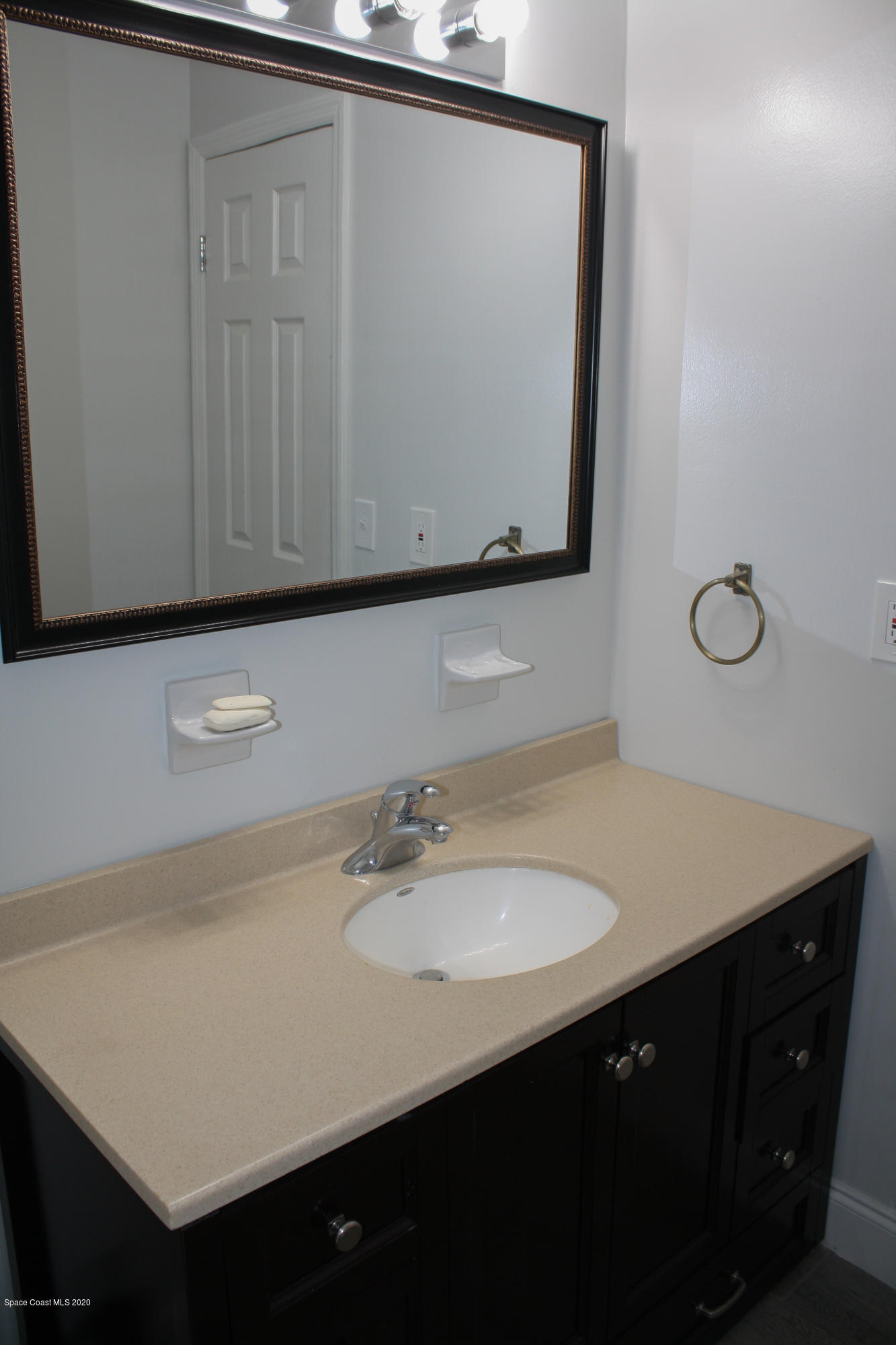 326 Riley Avenue Northeast Palm Bay, FL 32907 - Photo 25 of 43 a bathroom with a sink vanity and mirror