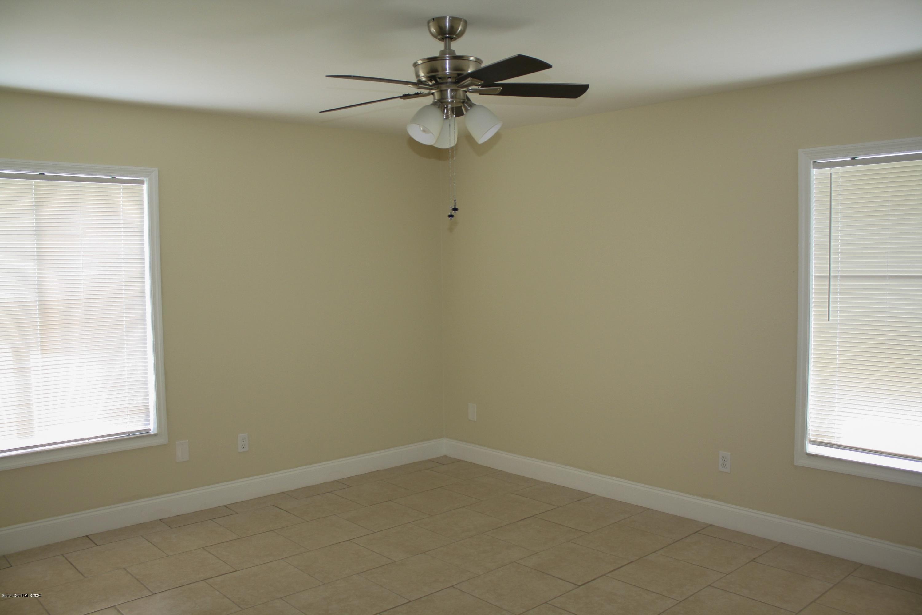 326 Riley Avenue Northeast Palm Bay, FL 32907 - Photo 26 of 43 an empty room with a window and a fan