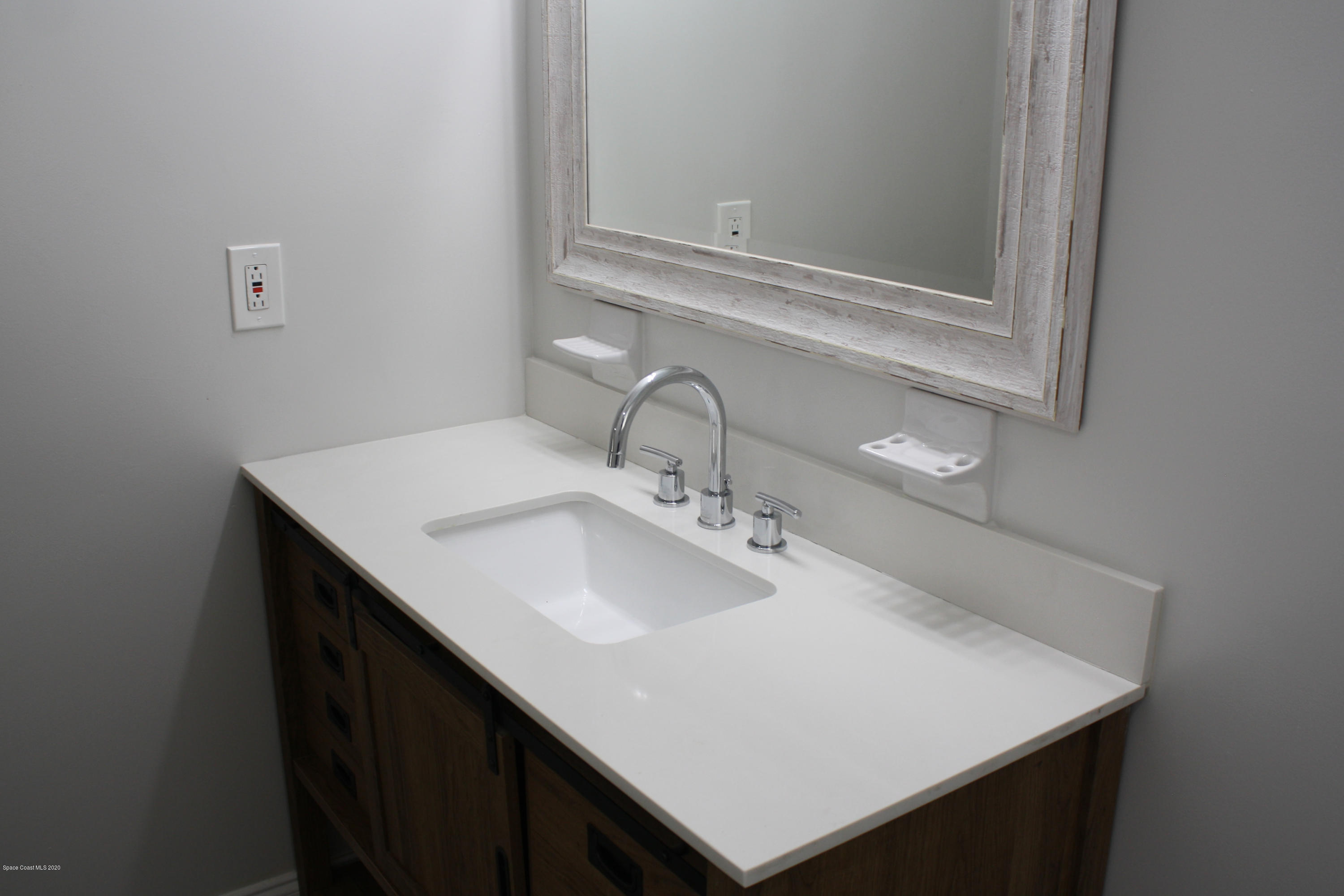 326 Riley Avenue Northeast Palm Bay, FL 32907 - Photo 28 of 43 a close up of a sink and a mirror