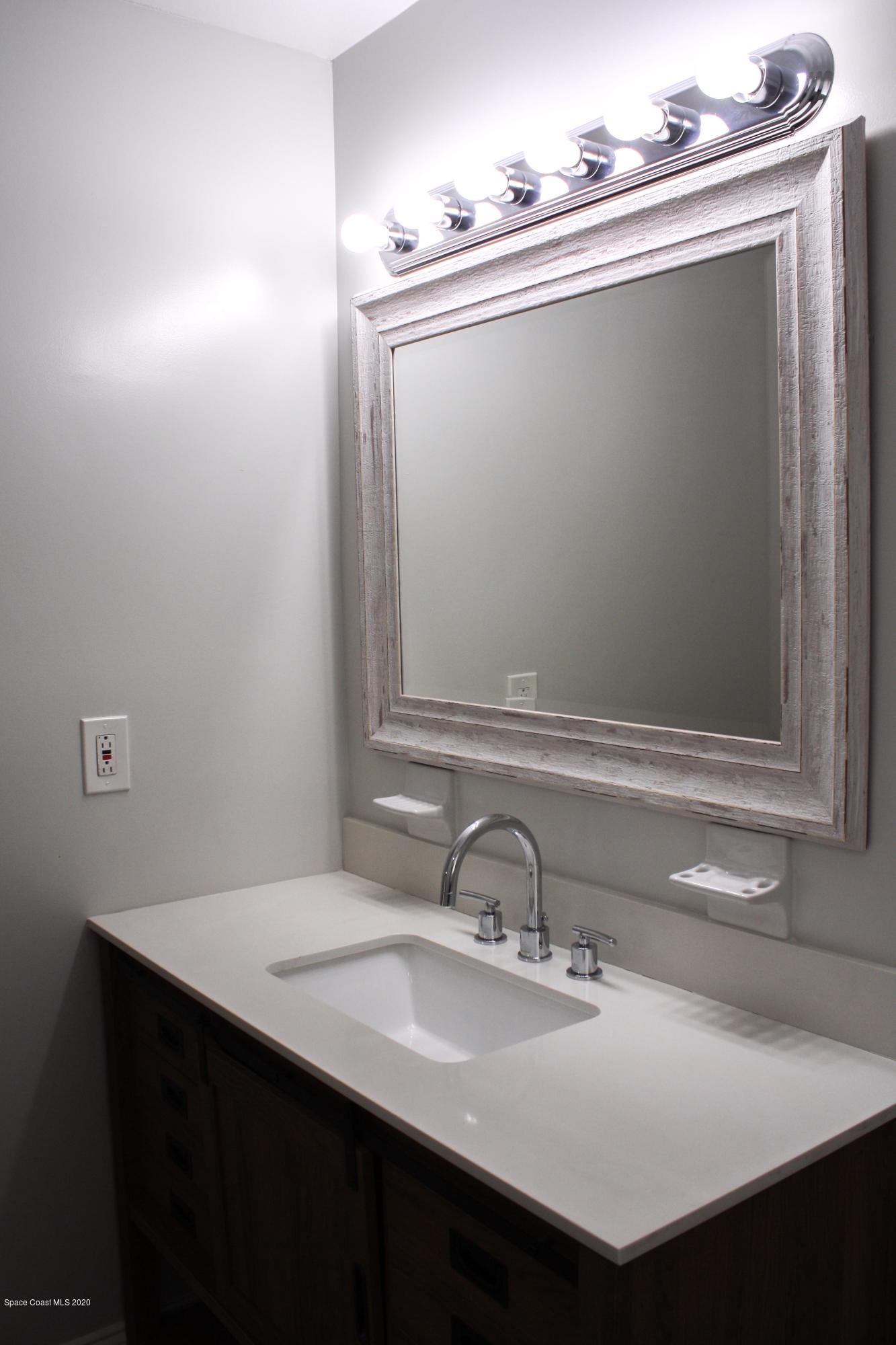 326 Riley Avenue Northeast Palm Bay, FL 32907 - Photo 29 of 43 a bathroom with a sink and a mirror