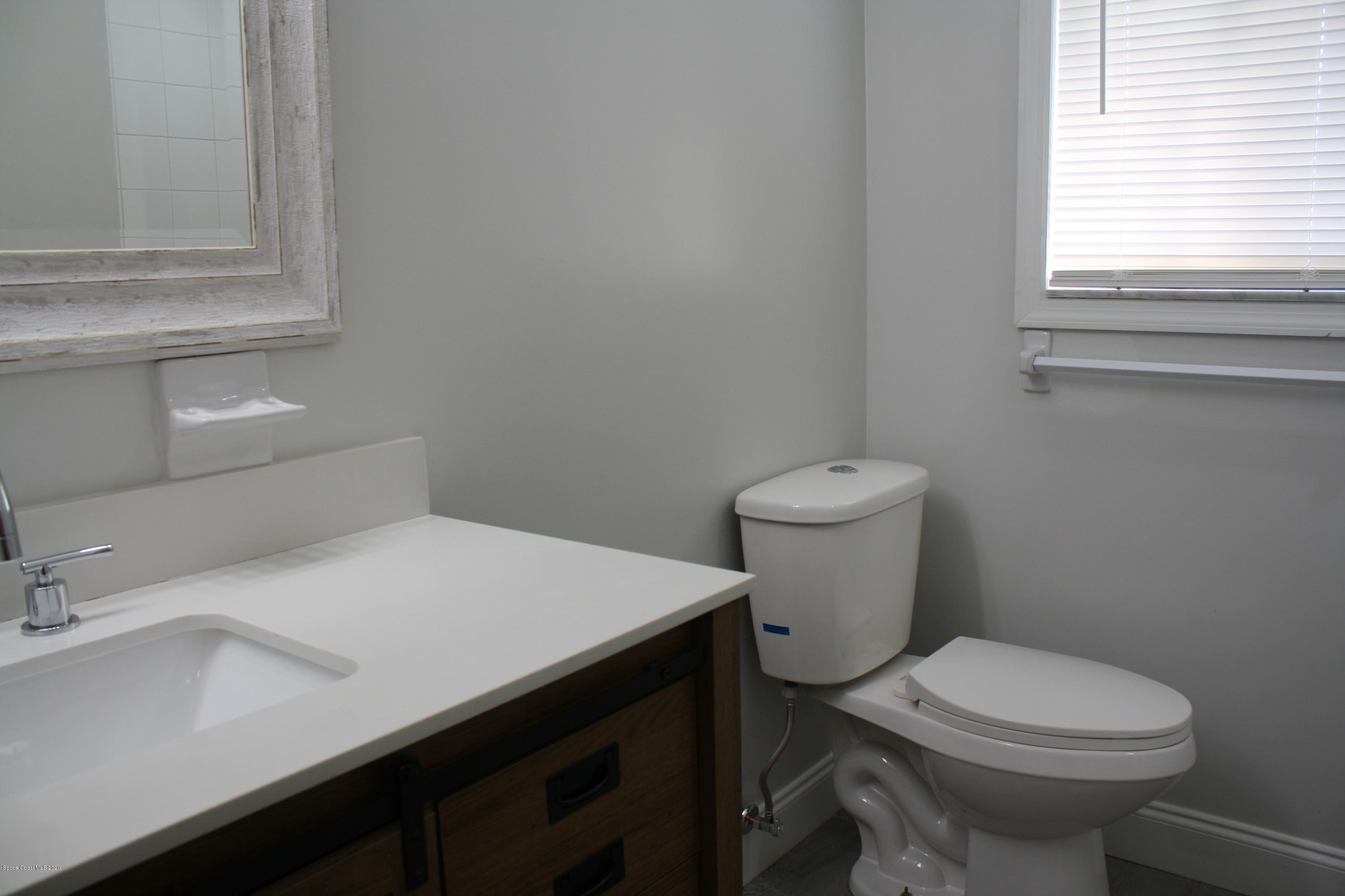 326 Riley Avenue Northeast Palm Bay, FL 32907 - Photo 30 of 43 a bathroom with a sink a toilet and a window