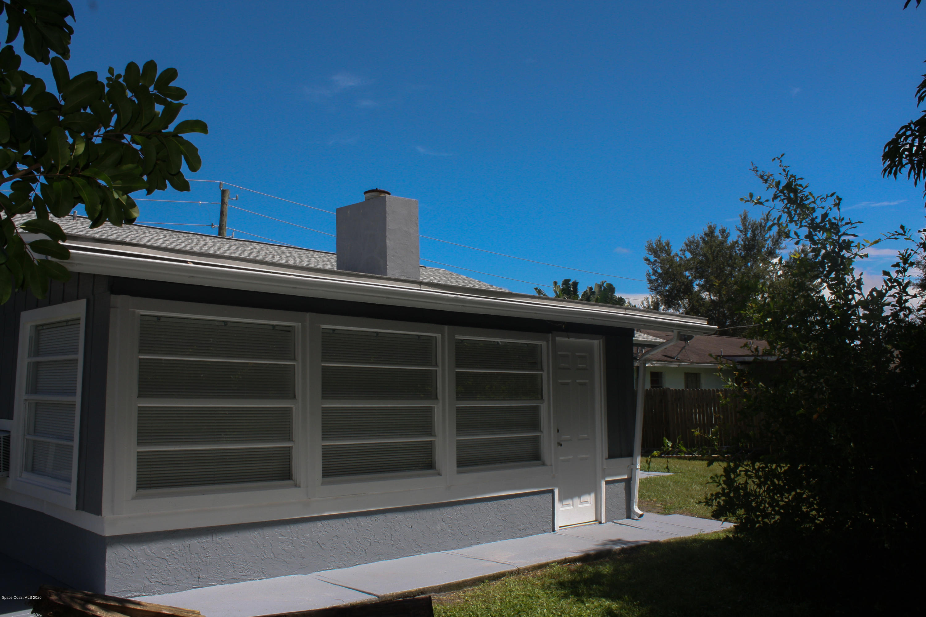 326 Riley Avenue Northeast Palm Bay, FL 32907 - Photo 38 of 43 a view of a house with a yard and potted plants