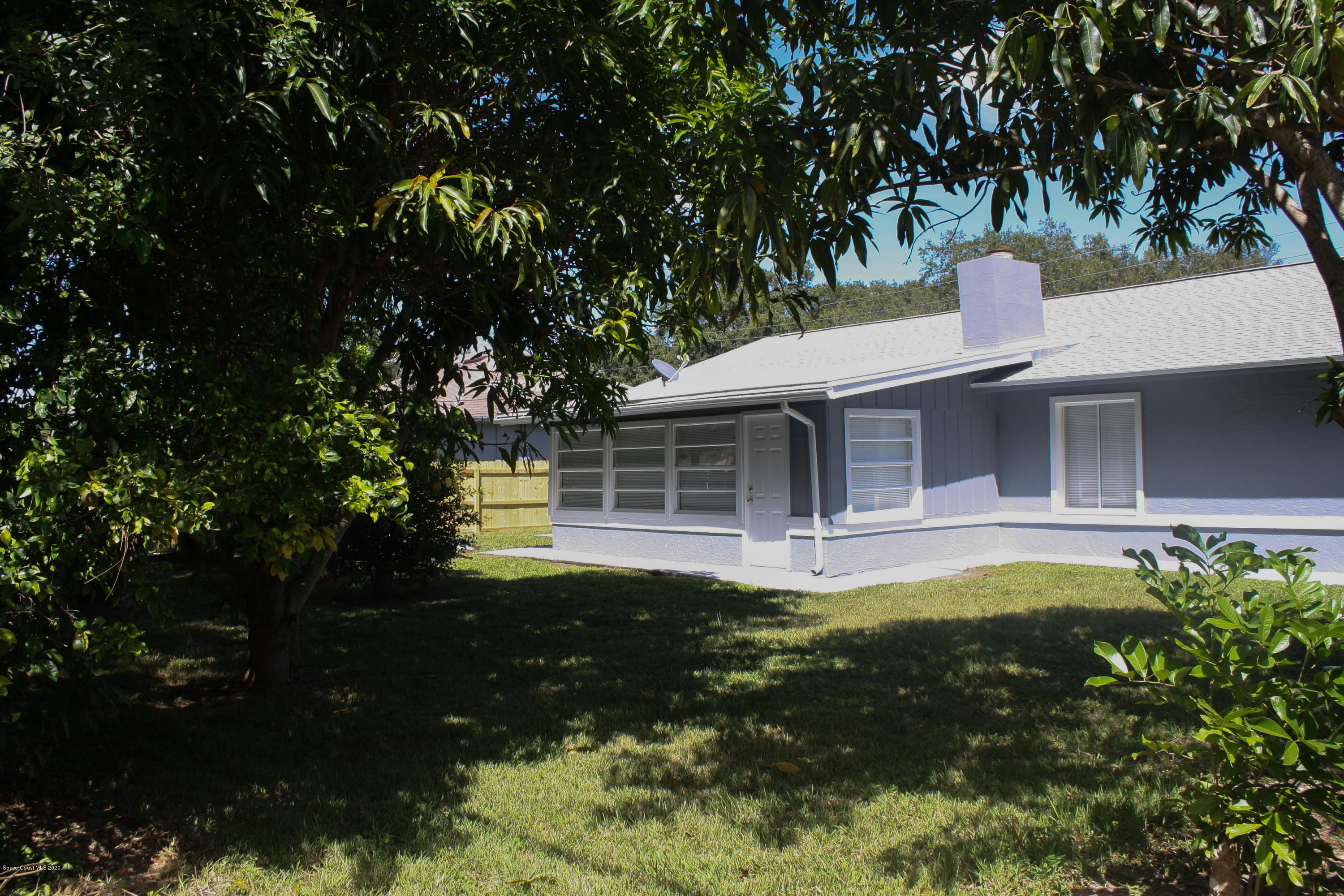 326 Riley Avenue Northeast Palm Bay, FL 32907 - Photo 39 of 43 a front view of a house with a garden