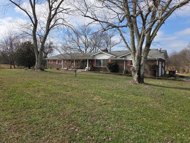 a view of a house with a yard