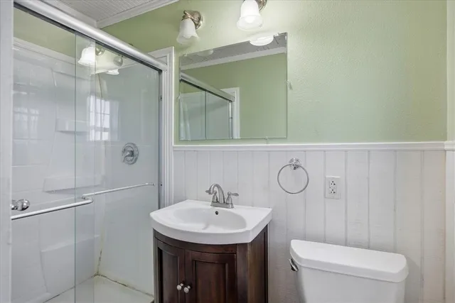 a bathroom with a sink a toilet and shower