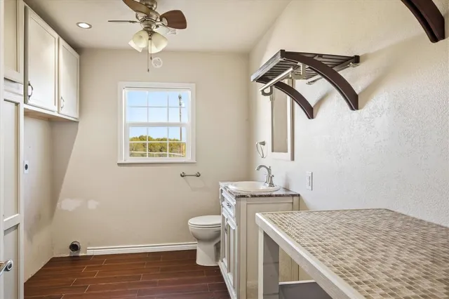 a bathroom with a sink a toilet and mirror