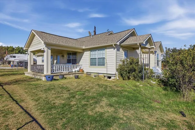a view of a house with a backyard