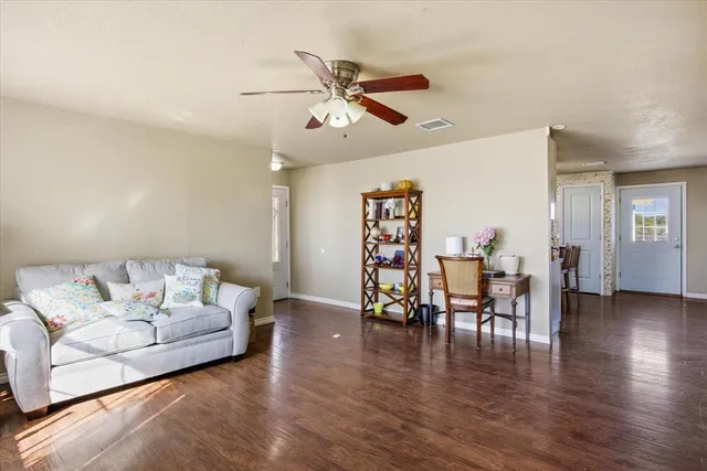 a living room with furniture and wooden floor