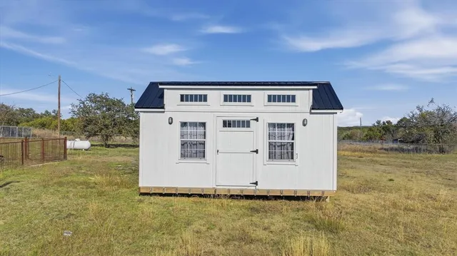 an aerial view of a house with a yard