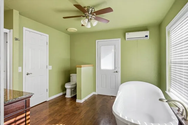a bathroom with a toilet and a mirror