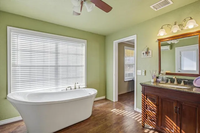 a bathroom with a bathtub and a sink