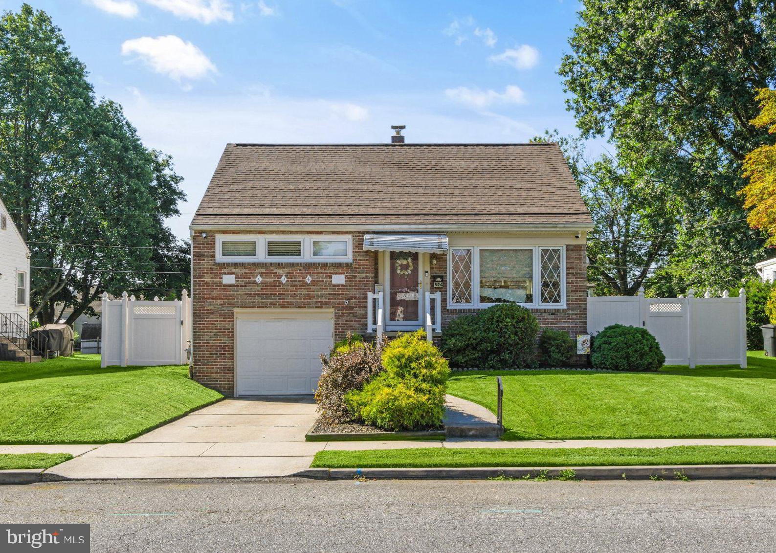 Charming brick home with lush greenery.