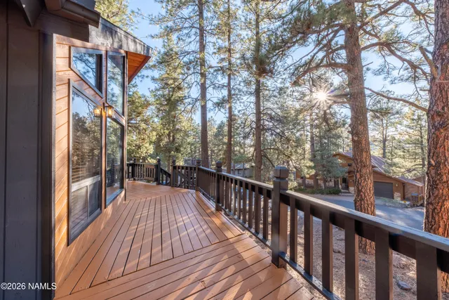 a front view of a house with a yard and tree s