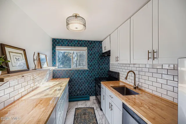 a kitchen with a sink and a stove top oven