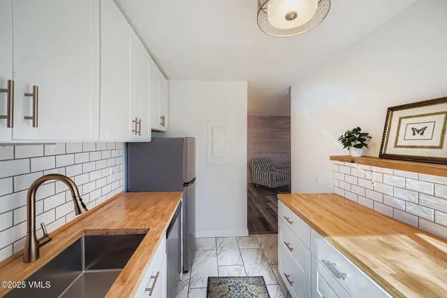a view of kitchen with faucet cabinets and outdoor space