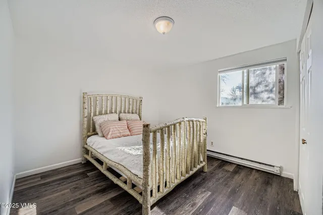 a bed sitting in a bedroom next to a window