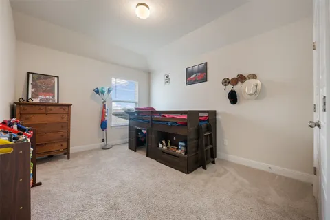 a bed room with a bed and a chair