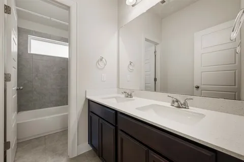 a bathroom with a sink a bathtub and a mirror