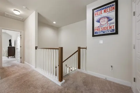 a view of a hallway with paintings on the wall