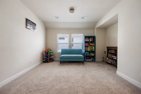 a view of an empty room with a window and workspace